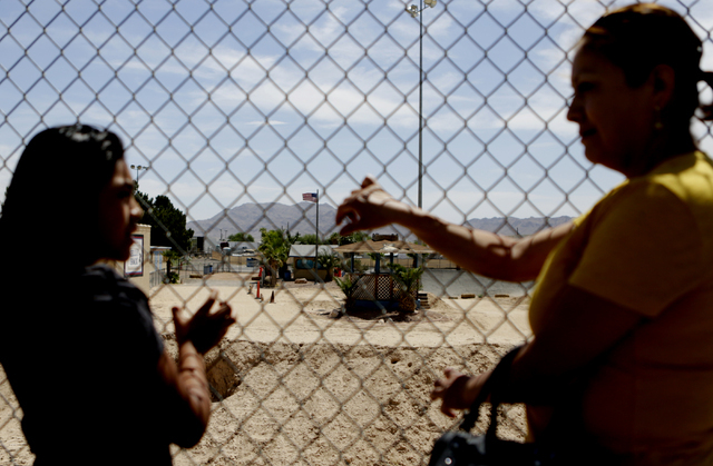 Francisca Sanchez, 41, right, and her daughter Karla Ortiz, 11, who don't want to show their face, pose for a photo during at Nellis Meadows Park on Thursday, June 9, 2016, in Las Vegas. (Bizuayeh ...