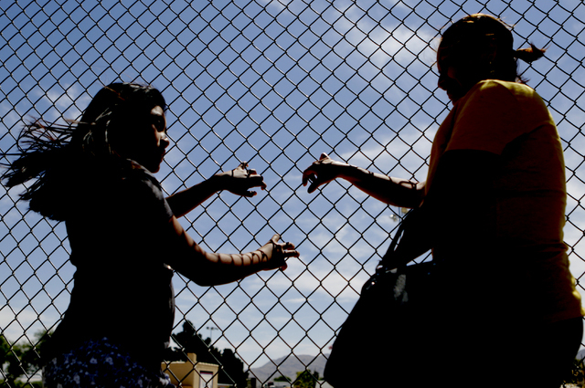 Francisca Sanchez, 41, right, and her daughter Karla Ortiz, 11, who don't want to show their face, pose for a photo during at Nellis Meadows Park on Thursday, June 9, 2016, in Las Vegas. (Bizuayeh ...
