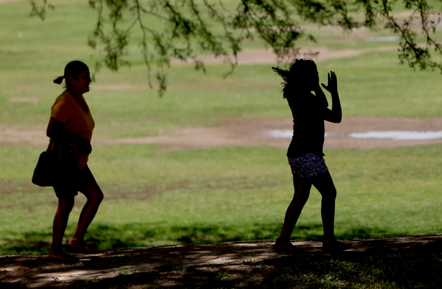 Francisca Sanchez, 41, and her daughter Karla Ortiz, 11, who don't want to show their face, walk at Nellis Meadows Park on Thursday, June 9, 2016, in Las Vegas. (Bizuayehu Tesfaye/Las Vegas Review ...