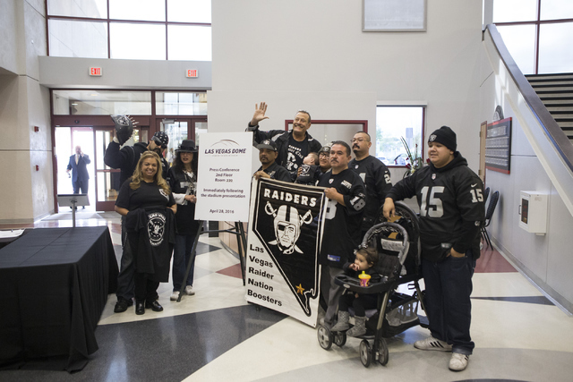 Fans pose inside the Stan Fulton Building at UNLV before a meeting with Oakland Raiders and local government and UNLV officials to discuss a proposed Las Vegas dome stadium on Thursday, April 28,  ...