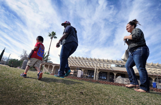 Foster parents Joseph, center, and Salvation Moore walk with one of their foster children on the campus of St. Jude's Ranch for Children in Boulder City on Friday, Feb. 6, 2015. (David Becker/Las  ...