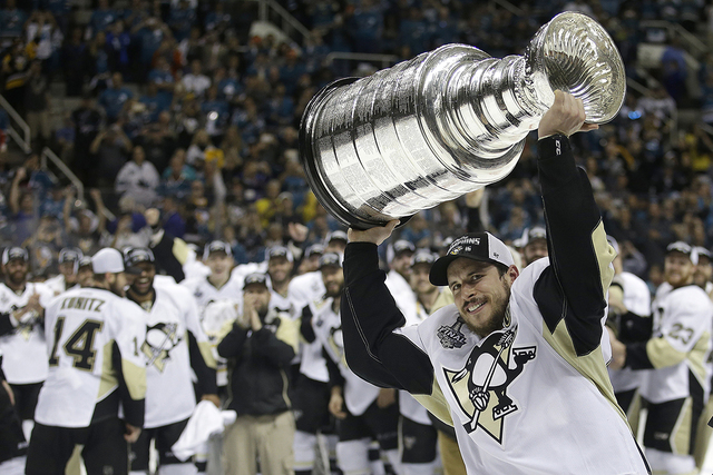 Pittsburgh Penguins center Sidney Crosby raises the Stanley Cup after Game 6 of the NHL hockey Stanley Cup Finals against the San Jose Sharks Sunday, June 12, 2016, in San Jose, Calif. The Pittsbu ...