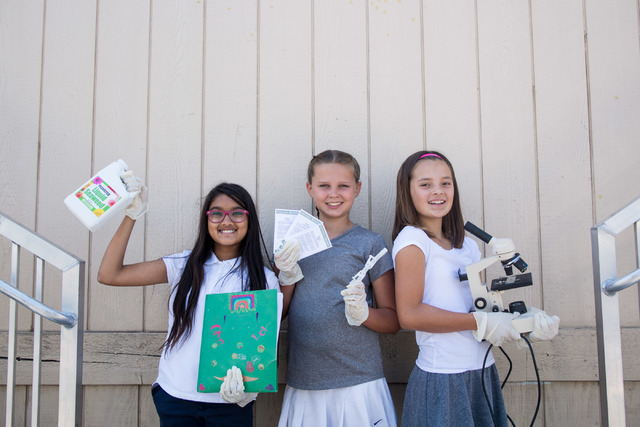 Shani Abeyakoon, left, Kendall Allgower, and Avery Sanford, fifth-grade students at John C. Vanderburg Elementary School, pose for a portrait using utensils they use while working on a seed experi ...