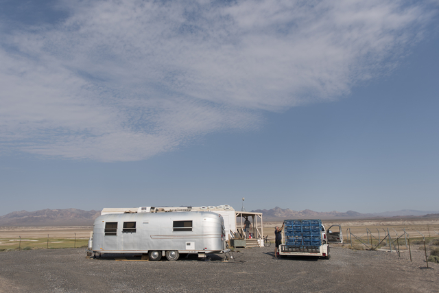 Larry Levy, fire chief with Southern Inyo Fire Protection District, right, and Jim Furlough, make their weekly potable water delivery rounds to residents in Tecopa, Calif. Tuesday, June 21, 2016. ...