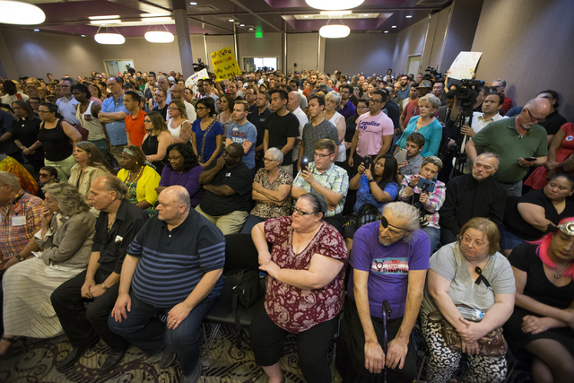 People attend a candle light vigil honoring the victims of the Orlando mass shooting at the The Gay and Lesbian Community Center of Southern Nevada on Sunday, June 12, 2016, in Las Vegas. (Erik Ve ...