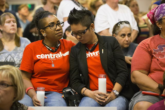 Jennifer White, left, and girlfriend Lady Binayan attend a candle light vigil honoring the victims of the Orlando mass shooting at the The Gay and Lesbian Community Center of Southern Nevada on Su ...