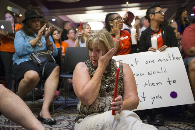 NVDEMS Chairwoman Roberta Lange wipes a tear during a candle light vigil honoring the victims of the Orlando mass shooting at the The Gay and Lesbian Community Center of Southern Nevada on Sunday, ...