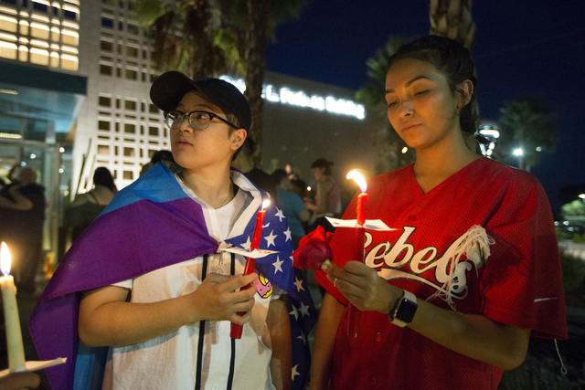 Alyssa Buhay, left, and girlfriend Nita Castro attend a candle light vigil honoring the victims of the Orlando mass shooting at the The Gay and Lesbian Community Center of Southern Nevada on Sunda ...
