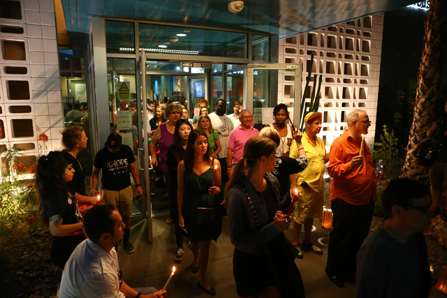 Attendees hold candles during the candle light vigil honoring victims of the Orlando mass shooting at the The Gay and Lesbian Community Center of Southern Nevada on Sunday, June 12, 2016, in Las V ...