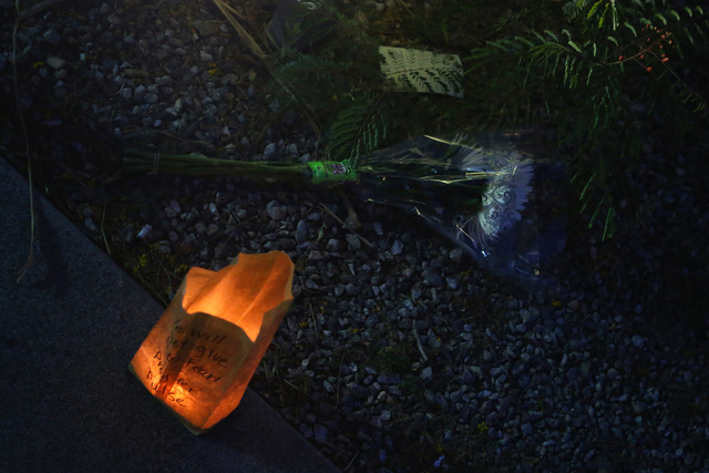 A candle and flowers sit outside of The Gay and Lesbian Community Center of Southern Nevada which honored the Orlando mass shooting victims in a candle light vigil on Sunday, June 12, 2016, in L ...