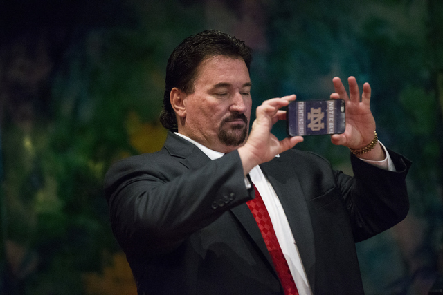 Nevada Republican Party Chairman Michael McDonald uses his phone during a campaign rally for Republican presidential candidate Donald Trump at the Treasure Island hotel-casino on Saturday, June 18 ...