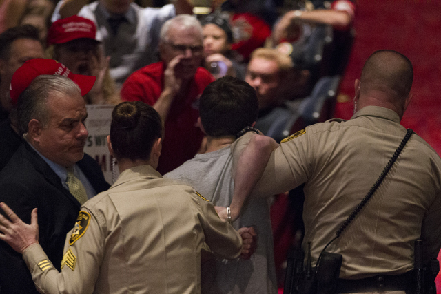 Michael Steven Sandford is escorted out during a campaign rally by Republican presidential candidate Donald Trump at the Treasure Island hotel-casino on Saturday, June 18, 2016, in Las Vegas. Erik ...