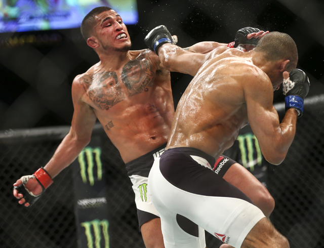 Edson Barboza, right, and Anthony Pettis trade punches during a lightweight bout in UFC 197 at the MGM Grand Garden Arena in Las Vegas on Saturday, April 23, 2016. Barboza won by unanimous decisio ...