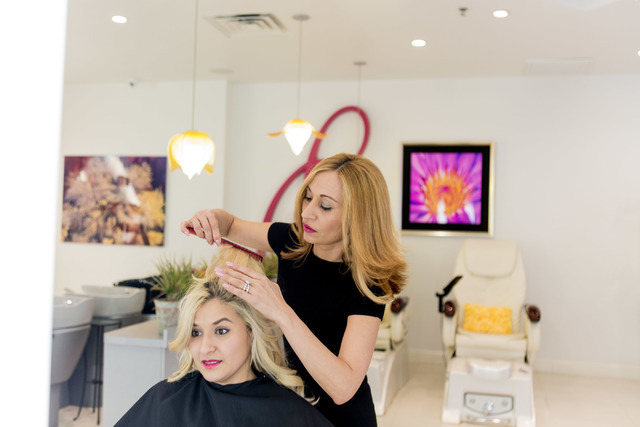 Beli Andaluz, owner and lead stylist of Beli Andaluz Salon, gives her assistant Anarely Nunez a trim at her salon in Las Vegas June 24, 2016. Elizabeth Brumley/Las Vegas Review-Journal Follow @eli ...