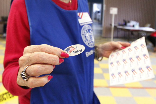 Volunteer handing out I Voted stickers. (Thinkstock)