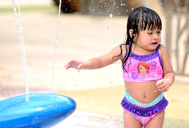 Faith Mena-Gutlay, 2, cools herself as she plays at Sunset Park on Thursday, June 9 , 2016, during a hot day. (Bizuayehu Tesfaye/Las Vegas Review-Journal) Follow @bizutesfaye