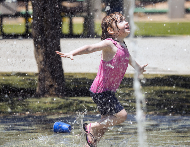 Kaitlyn Simpkins, 3, plays in a water fountain at Molasky Family Park on Monday, June 20, 2016. Jeff Scheid/Las Vegas Review-Journal Follow @jlscheid