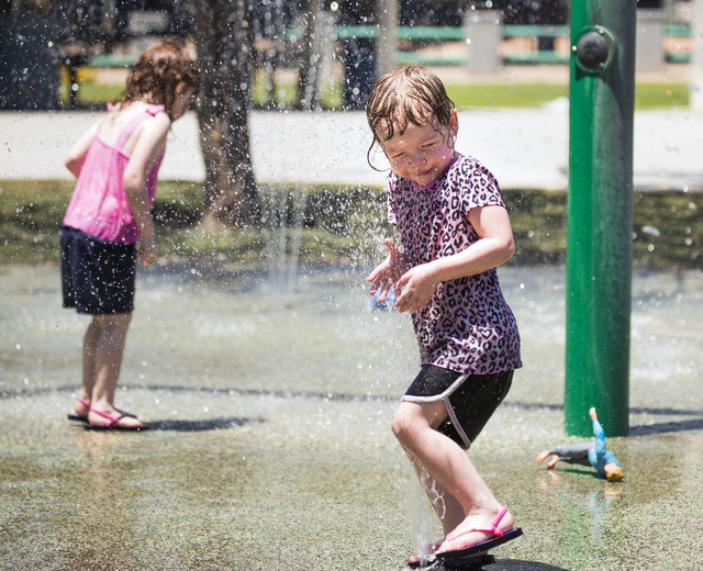 Kaitlyn Simpkins, 3, left and her sister Melinda, 2, play in a water fountain at Molasky Family Park on Monday, June 20, 2016. Jeff Scheid/Las Vegas Review-Journal Follow @jlscheid