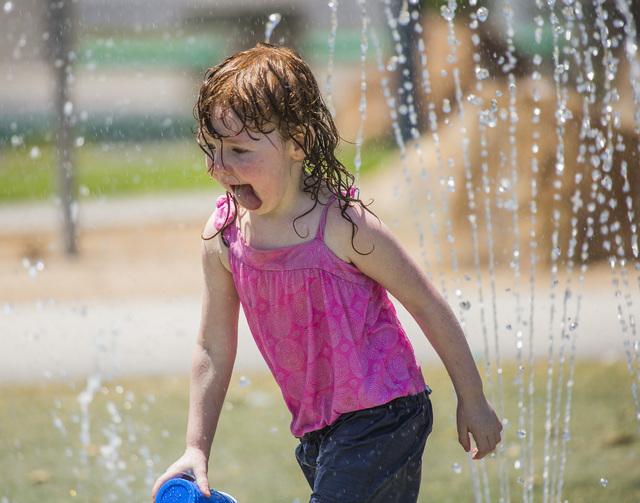 Kaitlyn Simpkins, 3, plays in a water fountain at Molasky Family Park on Monday, June 20, 2016. Jeff Scheid/Las Vegas Review-Journal Follow @jlscheid