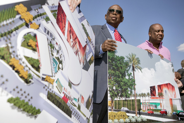 Gene Collins, left, a member of Moulin Rouge Holdings and Scott Johnson, a member of Moulin Rouge Holdings, holds a rendering during a groundbreaking at the original Moulin Rouge site at 900 W. Bo ...