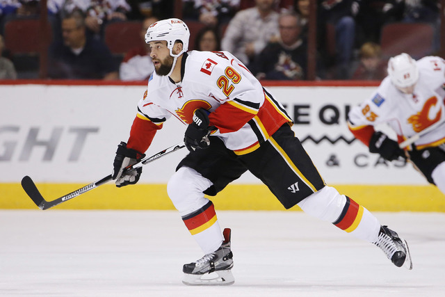 Calgary Flames' Deryk Engelland (29) skates to the puck against the Arizona Coyotes during the first period of an NHL game Friday, Nov. 27, 2015, in Glendale, Ariz. (Ross D. Franklin/AP)
