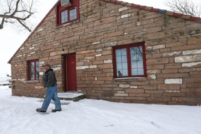 An anti-government protestor stands by a building at the Malheur National Wildlife Refuge headquarters, which the group is occupying, near Burns, Ore. on Monday, Jan. 4, 2016. (Chase Stevens/Las V ...