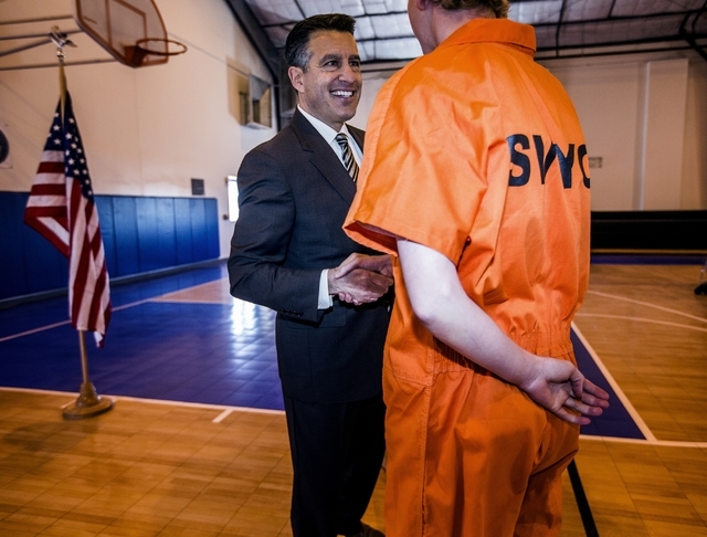 Nevada Gov. Brian Sandoval shakes hands with a juvenile at the Summit View Youth Correctional Center, a 48-bed facility in North Las Vegas, on Friday, Feb. 26, 2016. (Jeff Scheid/Las Vegas Review ...