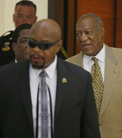 Bill Cosby, right, is surrounded by members of his security team as he walks to Courtroom A in the Montgomery County Courthouse in Norristown, Pennsylvania, July 7, 2016.  (Michael Bryant/Pool/Reu ...