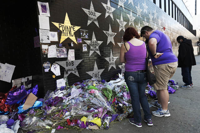 A star honoring Prince, now painted gold, stands out on the wall Thursday, May 5, 2016, as fans gathered at the memorial for the singer at First Avenue in Minneapolis where he often performed. The ...