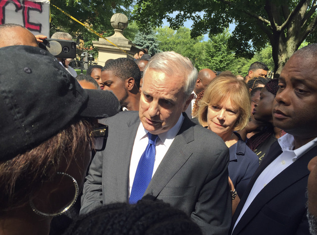 Minnesota Gov. Mark Dayton expresses his condolences to Diamond Reynolds for the death of her boyfriend, Philando Castile, outside the governor's residence Thursday, July 7, 2016, in St. Paul, Min ...