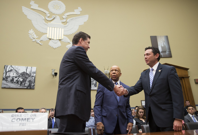 House Oversight and Government Reform Committee Chairman Rep. Jason Chaffetz, R-Utah, right, accompanied by the committee's ranking member Rep. Elijah Cummings, D-Md., center, welcome FBI Director ...