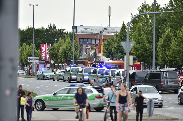 Police cars stand outside the Olympia shopping centre after a shooting was reported there in Munich, Friday, July 22, 2016. Several people have been reported to be killed. (Marc Kleine-Kleffmann/AP)