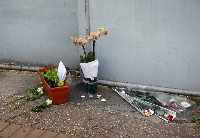 Flowers, candles and messages are placed at the home of the Rev. Jacques Hamel after he was killed during an attack in his church in Saint-Etienne-du-Rouvray, Normandy, France, Tuesday, July 26, 2 ...