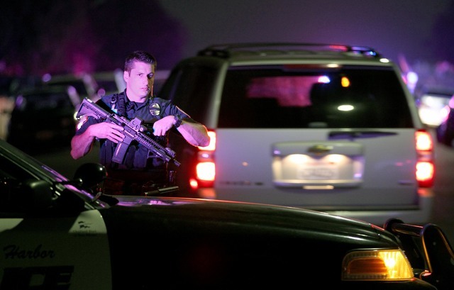 A San Diego Harbor Police officer helps to secure the scene in San Diego near where two San Diego police officers were shot Thursday night, July 28, 2016. (John Gastaldo/The San Diego Union-Tribun ...