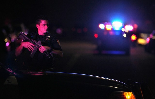 A San Diego Harbor Police officer helps to secure the scene in San Diego near where two San Diego police officers were shot Thursday night, July 28, 2016. (John Gastaldo/The San Diego Union-Tribun ...
