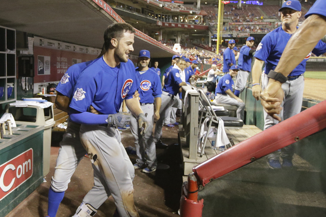Chicago Cubs third baseman Kris Bryant, center left, resists encouragement to wave to the crowd at a baseball game, Monday, June 27, 2016, in Cincinnati. The Cubs won 11-8. (John Minchillo/Associa ...