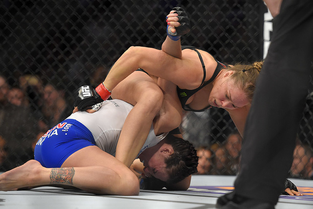 Ronda Rousey, right, grapples with Cat Zingano during a UFC 184 mixed martial arts bantamweight title bout, Saturday, Feb. 28, 2015, in Los Angeles. Rousey won after Zingano tapped out 14 seconds  ...