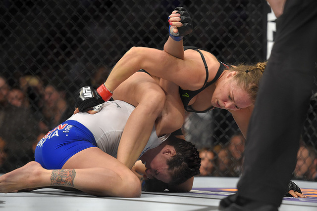 Ronda Rousey, right, grapples with Cat Zingano during a UFC 184 mixed martial arts bantamweight title bout, Saturday, Feb. 28, 2015, in Los Angeles. Rousey won after Zingano tapped out 14 seconds ...