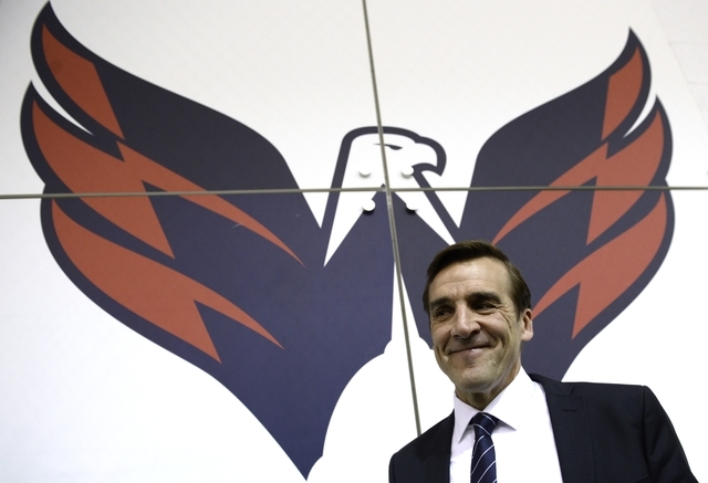 Washington Capitals former general manager George McPhee walks away from the podium after a news conference in Arlington, Va., Monday, April 28, 2014. (AP Photo)