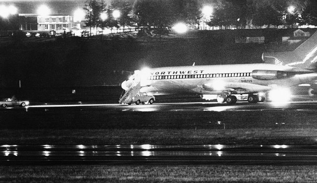 A hijacked Northwest Airlines jetliner is seen in this Nov. 25, 1971, file photo as it sits on a runway for refueling at Seattle-Tacoma International Airport, Nov. 25, 1971, Seattle. D.B. Cooper,  ...
