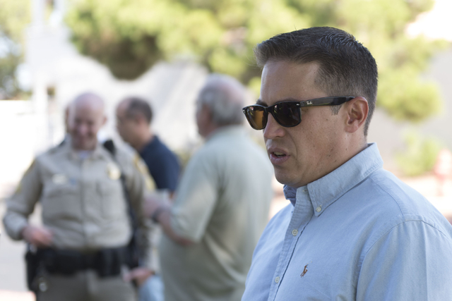 Pastor Matt Teis of Liberty Baptist Church speaks with a reporter during an outreach event held at Torrey Pines Condominiums following Wednesday night's quadruple murder-suicide of a family in Las ...