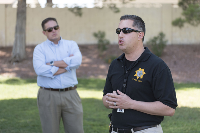 Las Vegas police Lieutenant Nicholas Farese, right, speaks to attendees during an outreach event held at Torrey Pines Condominiums following Wednesday night's quadruple murder-suicide of a family ...