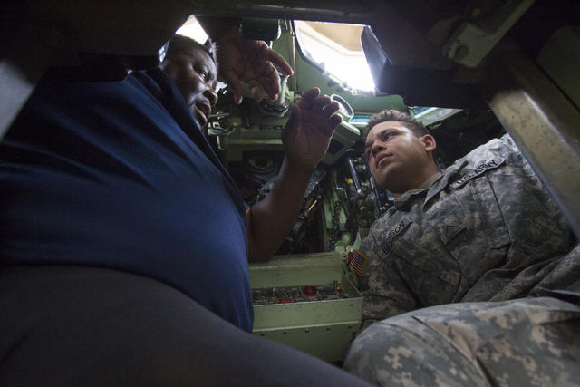 Training specialist Kenneth Pitts, left, goes over the A-3 Bradley fighting vehicle with Private Michael Barnson during a training exercise at the Clark County Armory on Friday, July 29, 2016. Ric ...