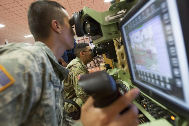 Nevada National Guard soldiers Michael Azcunaga, left, and Pedro Castillo are seen while training on a Bradley desktop simulator at the Clark County Armory on Friday, July 29, 2016. Richard Brian/ ...