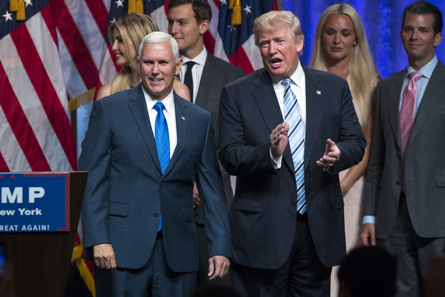 Donald Trump, right, introduces Gov. Mike Pence, R-Ind., during a campaign event to announce Pence as the vice presidential running mate on, Saturday, July 16, 2016, in New York. (Evan Vucci/The A ...