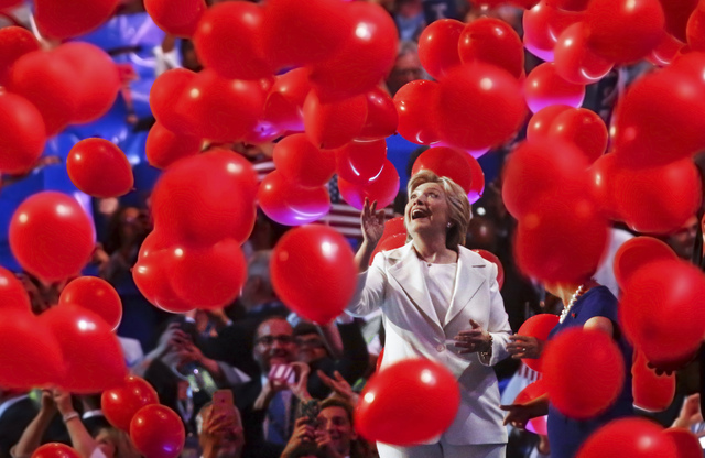 Democratic presidential nominee Hillary Clinton walks off stage through a sea of balloons during the final day of the Democratic National Convention at the Wells Fargo Center on Thursday, July 28, ...