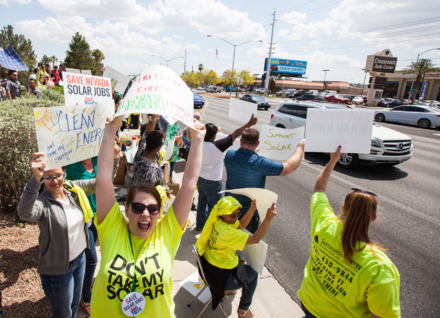 Solar energy supporters, including Marie Galbraith, lower left, protest outside of NV Energy at 6226 W. Sahara Ave. on Wednesday, April 22, 2015. (Chase Stevens/Las Vegas Review-Journal) Follow Ch ...