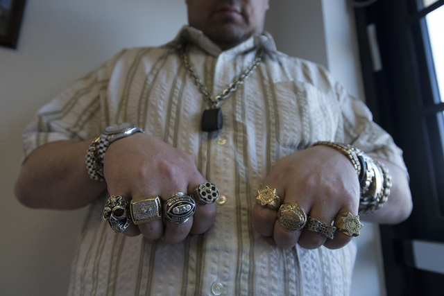 Owner of Nevada Coin Mart Neil Sackmary shows off his rings at his store in Las Vegas June 23. Bridget Bennett/View