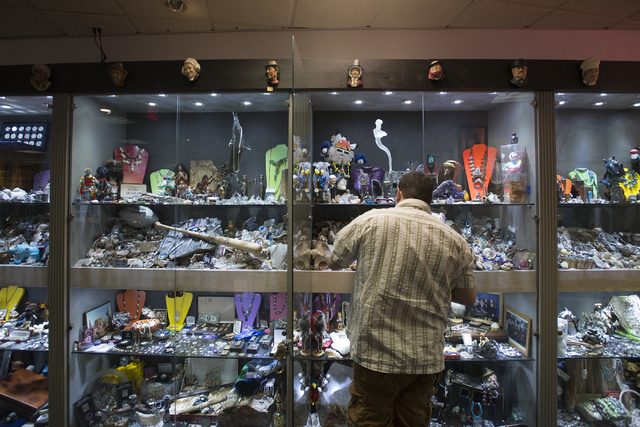 Owner of Nevada Coin Mart Neil Sackmary searches though his display case at his store at 4065 S. Jones Blvd. in Las Vegas June 23. Bridget Bennett/View  Follow @bridgetkbennett on Twitter