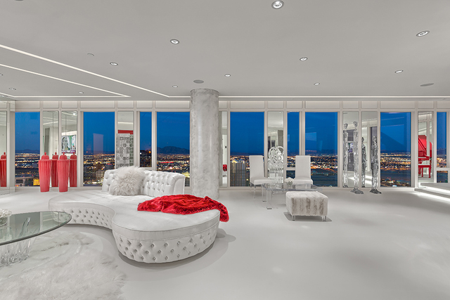 In the fully furnished main living room, bursts of the color red were incorporated in the design. (Courtesy of Luxury Estates International)
